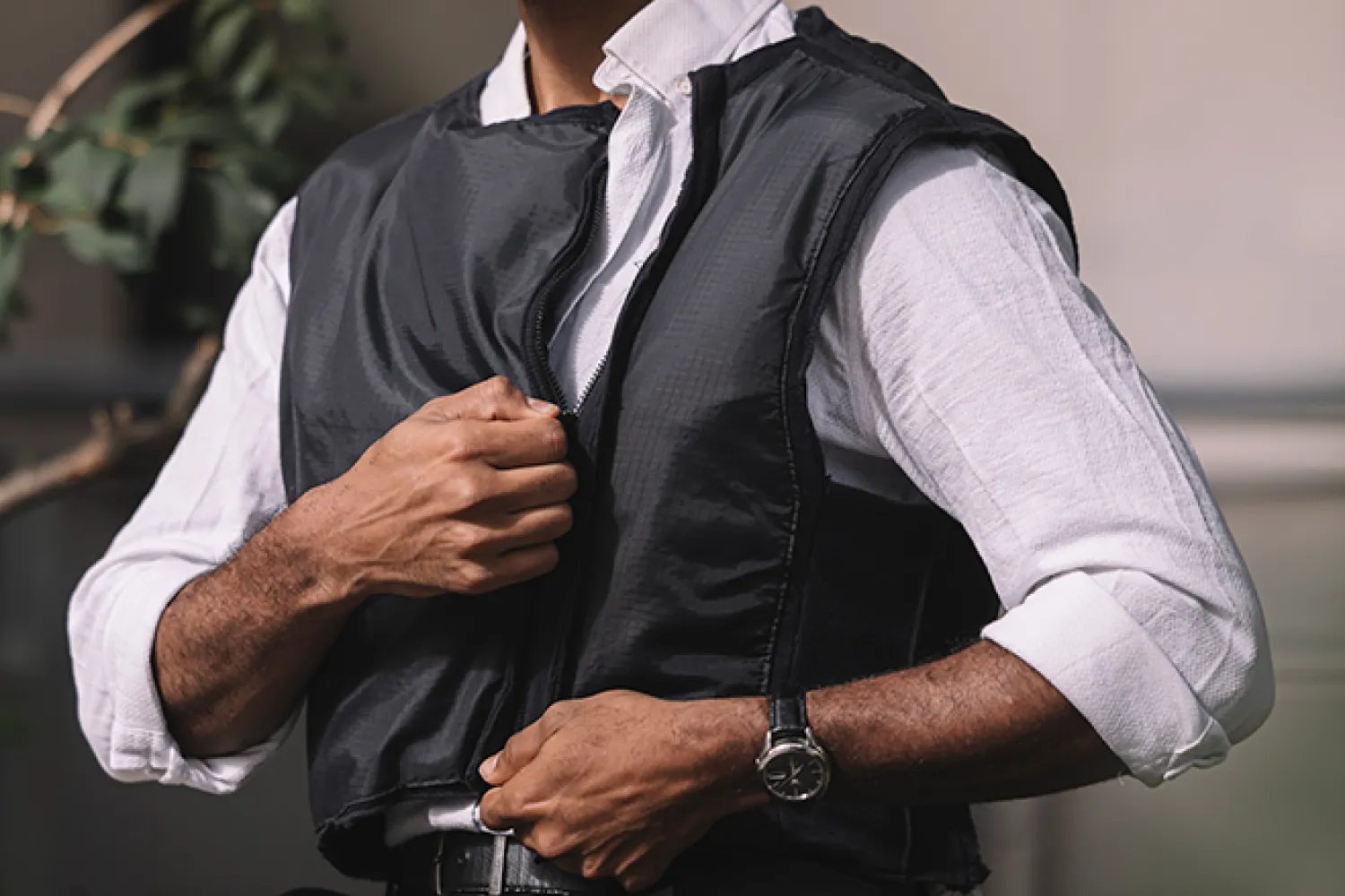 A person zipping up the ProActive vest prototype